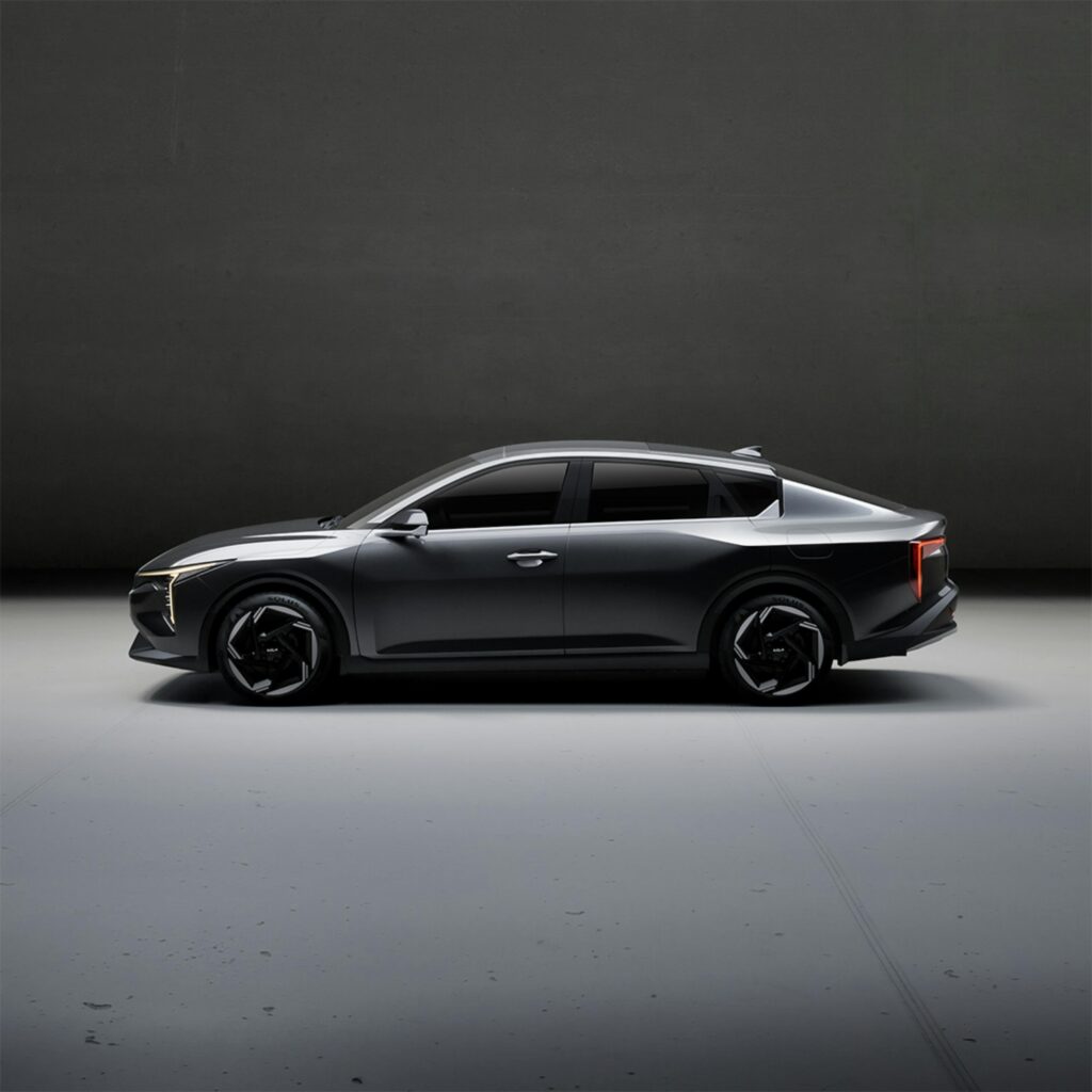 Sleek electric car showcased in a minimalist indoor studio setting, highlighting design and innovation.